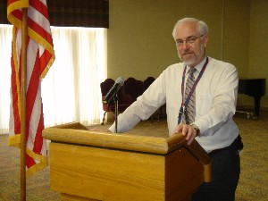 Hervey Martin-Rude of the Intelligence Electronic Warfare Test Directorate addresses the audience during the March meeting.